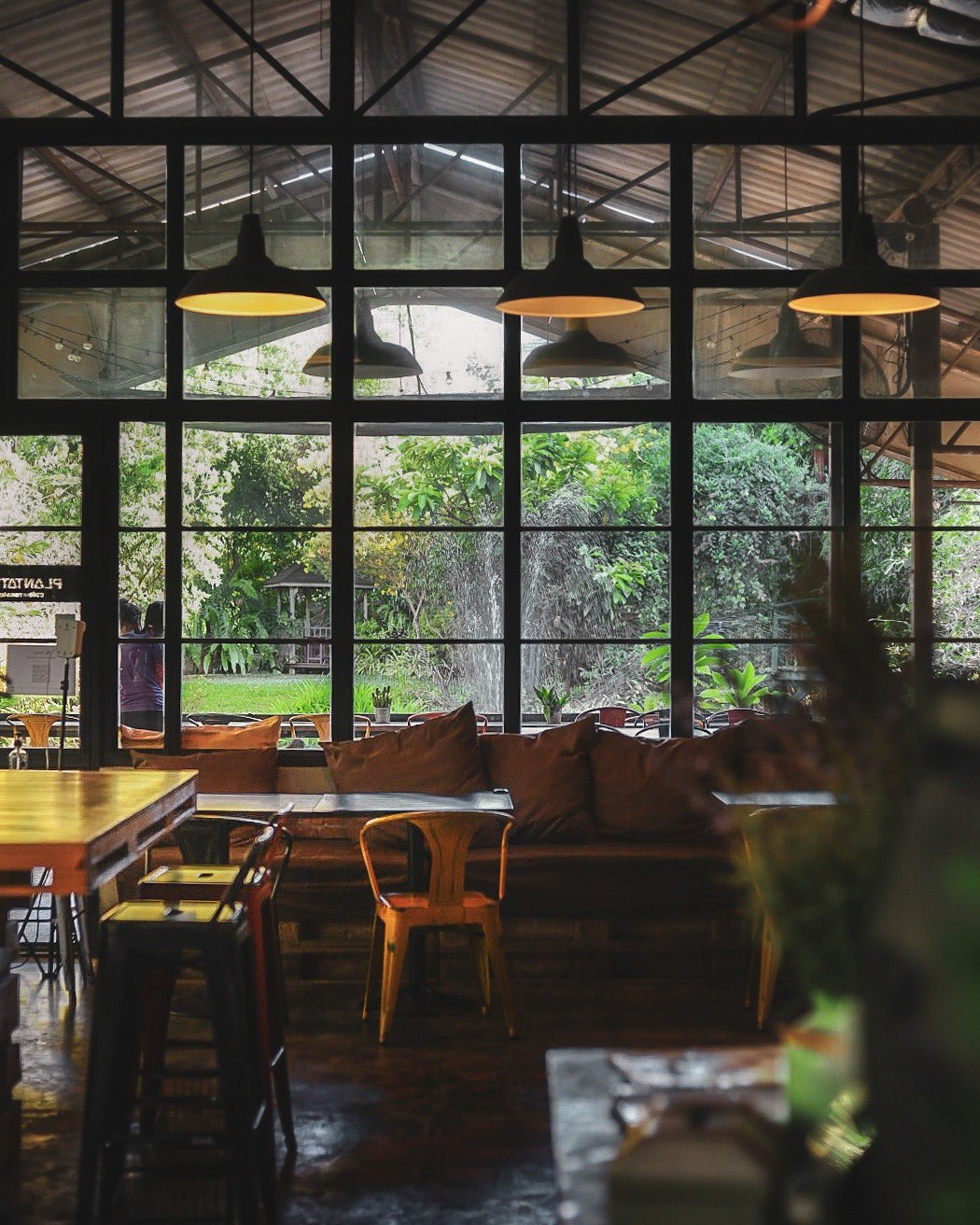 Interior seating area with glass walls and garden views